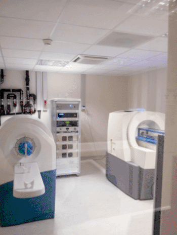 Image: The new benchtop 3T MRI scanner (left) located near other laboratory equipment (Photo courtesy of MR Solutions).